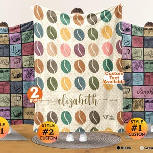 May include: A rectangular throw blanket featuring a repeating pattern of multicolored coffee beans on a cream background, with the name "elizabeth" printed in cursive script, and a "Custom Text Available" label.