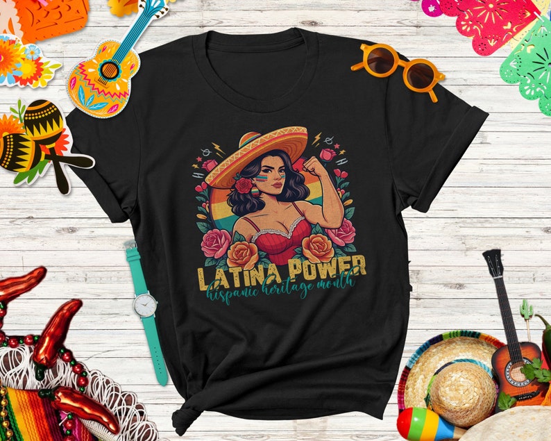 May include: Black t-shirt with a retro-style illustration of a woman wearing a sombrero and a red top. The text "Latina Power" and "Hispanic Heritage Month" is printed on the shirt.