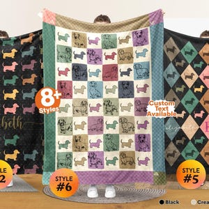May include: Three rectangular fleece blankets featuring dachshund illustrations. The left blanket is black with a repeating dog pattern and the name elizabeth. The center blanket has a grid of colorful squares with dog sketches. The right blanket has a diamond pattern with the name elizabeth and the letter E.