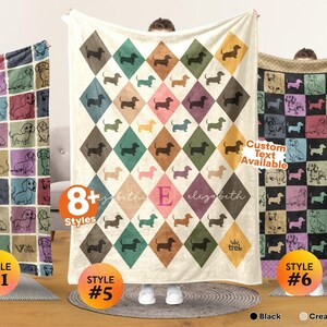 May include: Three fleece blankets featuring dachshund illustrations. The left blanket has a grid of colorful squares with dog outlines. The center blanket displays a diamond pattern with dachshund silhouettes and the name Elizabeth with an E. The right blanket shows a grid of colorful squares with dog outlines.