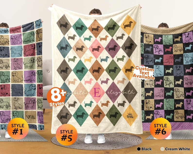 May include: Three fleece blankets featuring dachshund illustrations. The left blanket has a grid of colorful squares with dog outlines. The center blanket displays a diamond pattern with dachshund silhouettes and the name Elizabeth with an E. The right blanket shows a grid of colorful squares with dog outlines.
