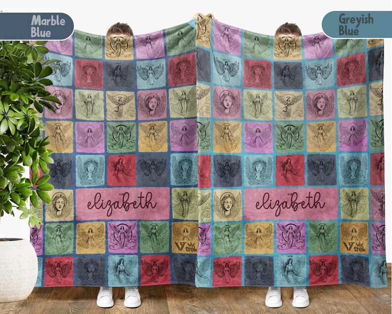 May include: A rectangular blanket featuring a grid of colorful squares, each containing a line-art illustration of an angel. A central rectangular panel displays the name "elizabeth" in a cursive script. The blanket displays various shades of blue, pink, yellow, and green.