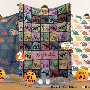 May include: Three rectangular blankets featuring repeating animal patterns. The center blanket displays a grid of bears in various colors with the name elizabeth printed in the middle. The left blanket is blue and the right blanket is cream white.