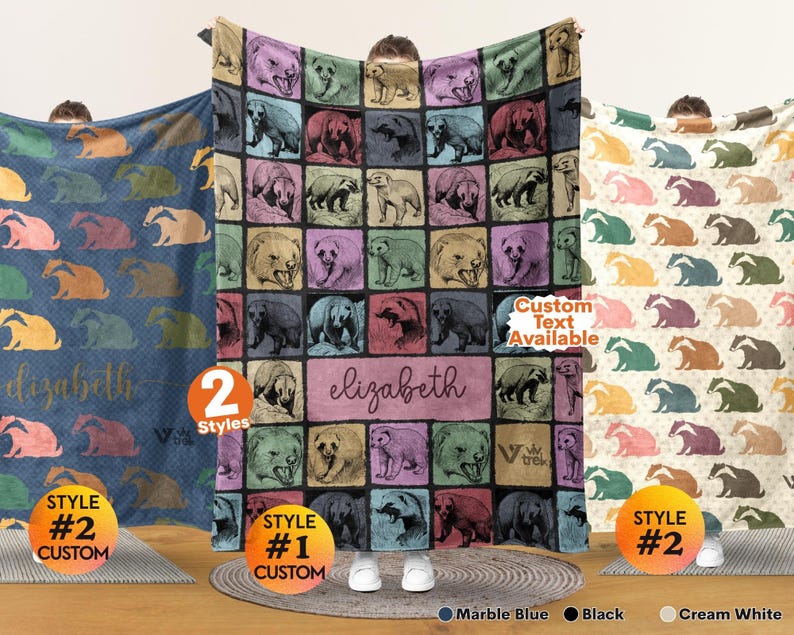 May include: Three rectangular blankets featuring repeating animal patterns. The center blanket displays a grid of bears in various colors with the name elizabeth printed in the middle. The left blanket is blue and the right blanket is cream white.