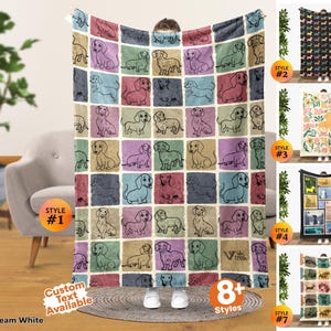 May include: A rectangular throw blanket featuring a grid pattern of individual squares, each containing a line-art illustration of a dachshund dog. The squares are colored in various muted tones including blue, pink, tan, and green. The text VIV TREK is visible.