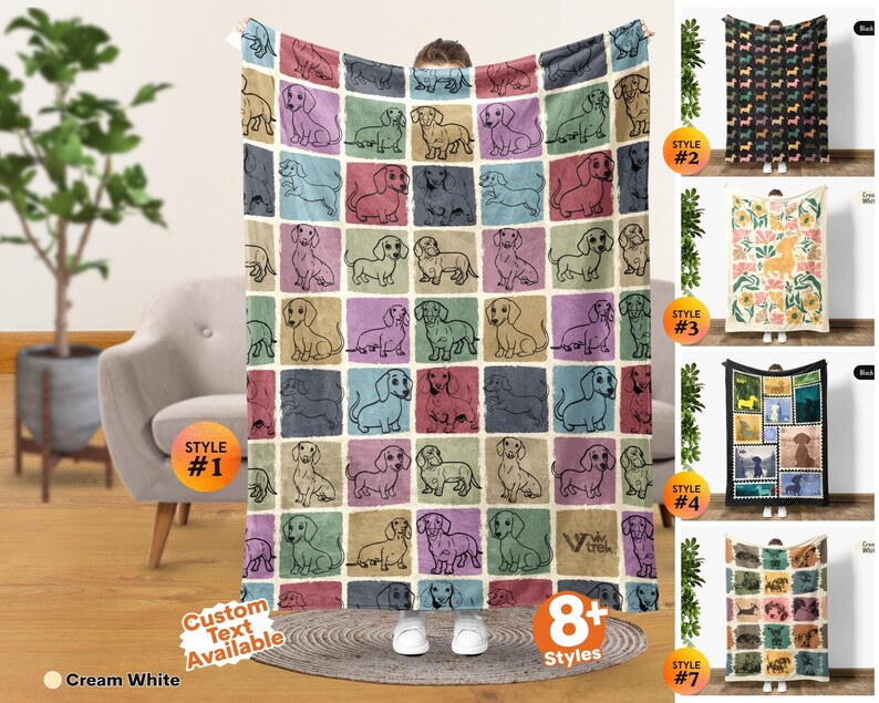 May include: A rectangular throw blanket featuring a grid pattern of individual squares, each containing a line-art illustration of a dachshund dog. The squares are colored in various muted tones including blue, pink, tan, and green. The text VIV TREK is visible.
