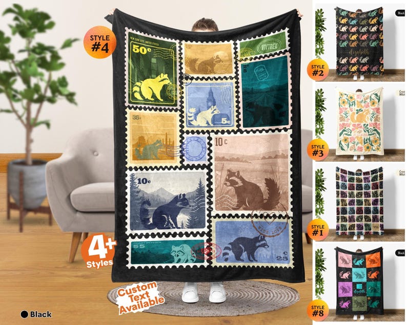May include: A black fleece blanket featuring a collage of vintage-style postage stamp graphics, each displaying a raccoon illustration in various colors and settings, with numerical values like 50c, 10c, 35c, and 55c printed on the individual stamp designs.