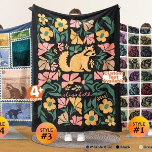 May include: Three rectangular blankets featuring raccoon designs. The left blanket has a postage stamp grid pattern. The center black blanket displays a large raccoon surrounded by pink and yellow flowers with the name elizabeth. The right blanket has a grid of raccoon illustrations. Text includes 4+ Styles, Custom Text Available, and vivtrek.