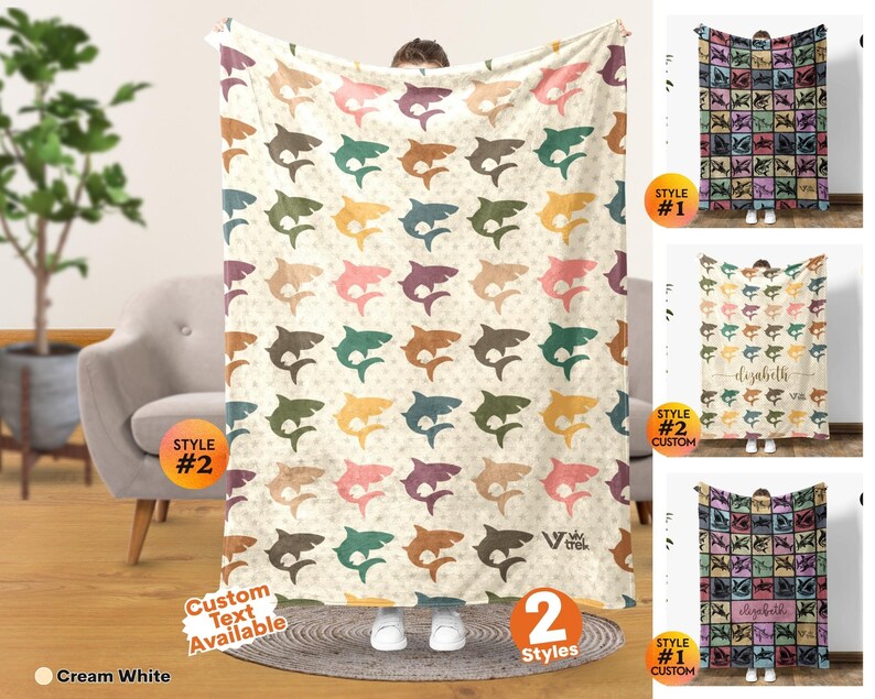 May include: A cream white throw blanket featuring a repeating pattern of sharks in various colors including teal, orange, pink, and brown. The blanket displays the Viv Trek logo in the bottom right corner and offers custom text options.