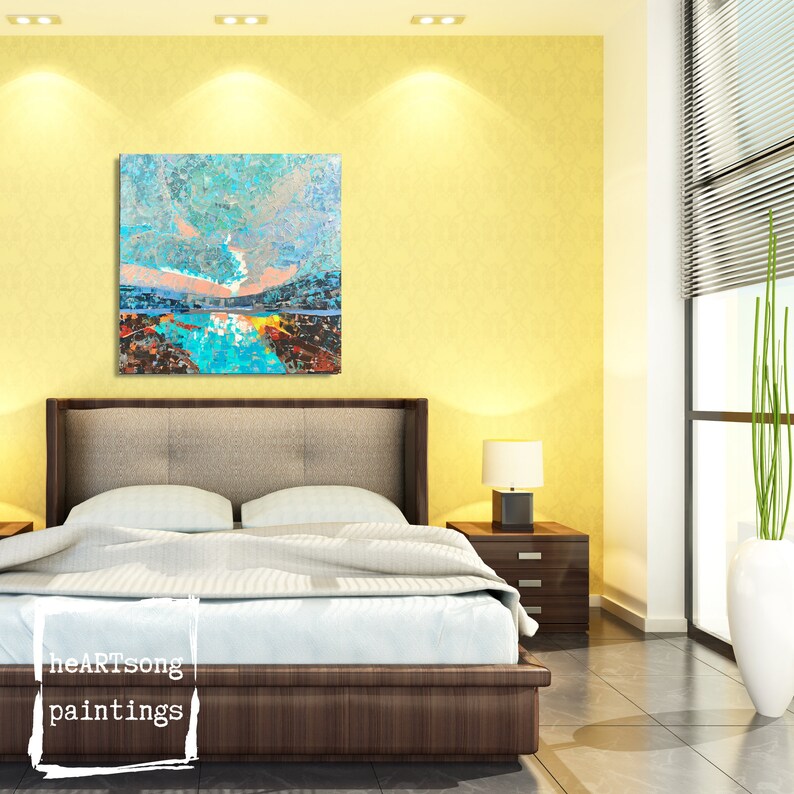 May include: A bedroom interior with a modern bed, a bedside table, and a large abstract painting on the wall. The painting features a blue and green landscape with a pink sky.