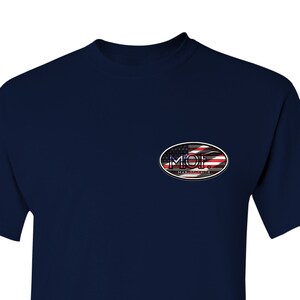 May include: A navy blue t-shirt with a small oval patch on the left chest. The patch features an American flag design with the text "MOF. Made in the USA."