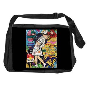 May include: Black messenger bag featuring a vibrant pop art design. The artwork shows a kissing couple, set against a backdrop of graffiti-style text and images. It has a black adjustable strap.