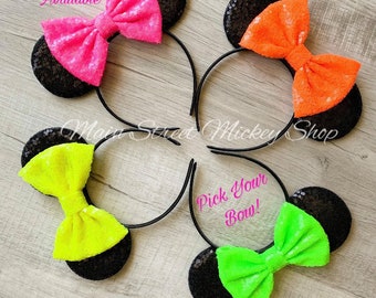 May include: Four headbands with black sequined mouse ears and colorful sequined bows. The bows are in neon pink, orange, yellow, and green. Text on the image says "40 Colors Available" and "Pick Your Bow!"