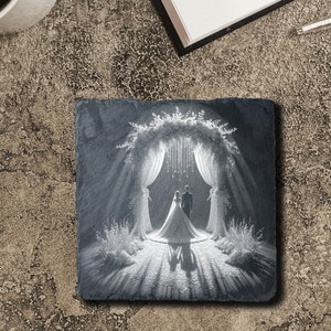 May include: A black slate coaster with a white engraved image of a wedding ceremony. The couple is standing under a floral archway with white drapes.