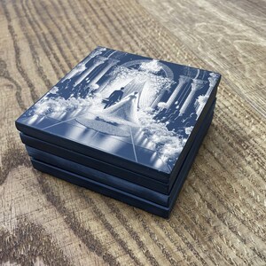 May include: A set of four blue square coasters with a white design of a wedding ceremony. The design features a bride and groom walking down the aisle.