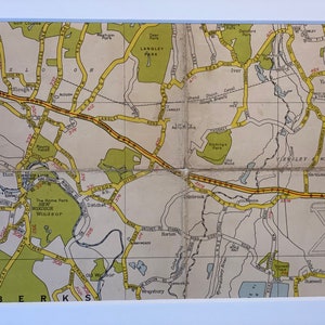 May include: A vintage map of the Windsor area in England, showing the towns of Slough, Datchet, Windsor, Iver, Yiewsley, and West Drayton. The map is printed on paper and has a yellowed appearance. The map is divided into sections, with each section showing a different part of the area. The map is labelled with the names of the towns and roads, as well as other features such as parks and rivers.