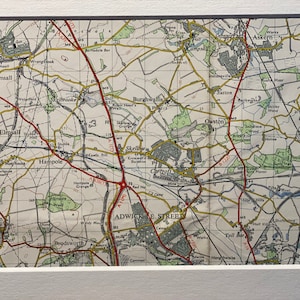 May include: A vintage map of the area around Adwick le Street, England, with towns and villages labeled in black text. The map is printed on cream-colored paper and features red and yellow lines indicating roads and railways.