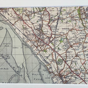 May include: A vintage map of the Wirral Peninsula in England, showing the towns of Neston, Gayton, Thornton Hough, and Poulton. The map is printed in black and white with red lines indicating roads and railways.
