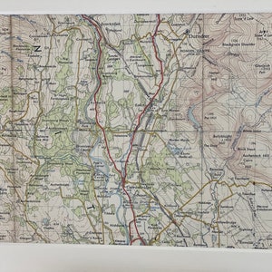 May include: A vintage map of the Durisdeer area in Scotland, showing the location of Roman Camps, Carronbridge, and other landmarks. The map is printed in black and white with red lines indicating roads and rivers.