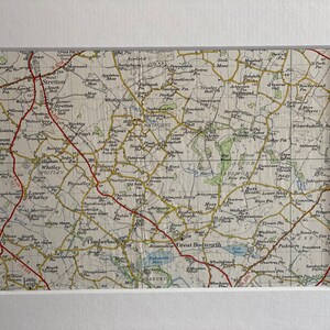 May include: A vintage map of the English countryside, featuring the towns of Stretton, Whittley, and Great Budworth. The map is printed on paper with a cream background and brown lines. The map is framed in a white mount.