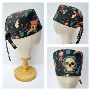 May include: A black surgical scrub cap with a repeating pattern of plague doctor masks, skulls, rats, and potion bottles. The cap has a tie in the back for an adjustable fit. The fabric is dark with colorful accents.