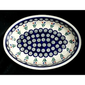 May include: An oval ceramic serving dish with a blue and white pattern of circles and a border of red and green flowers.