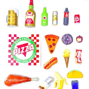 May include: A collection of miniature food and drink items, including a pizza box, a slice of pizza, a hot dog, a banana, a taco, a chicken leg, a donut, an ice cream cone, a soda can, a bottle of beer, a glass of beer, and a bottle of soda. The items are all made of plastic and are arranged on a white background.