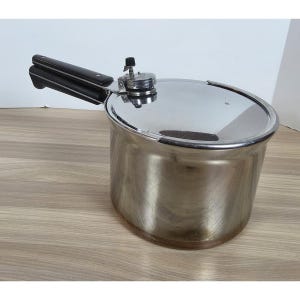 May include: A stainless steel pressure cooker with a polished silver finish, featuring a long black handle and a circular lid with a central pressure regulator valve. The pot has a cylindrical body and a flat base, designed for stovetop use.