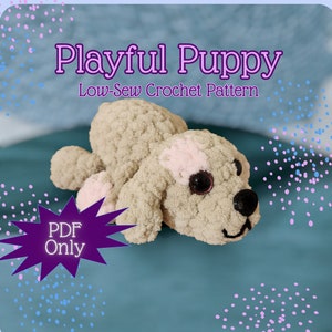 May include: A crocheted plush puppy toy in beige with pink accents. The puppy is lying on its side with its head turned to the side. The text "Playful Puppy Low-Sew Crochet Pattern PDF Only" is displayed above the puppy.