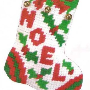May include: A red and green Christmas stocking with the word "HOLLY" embroidered on it. The stocking is filled with a giraffe toy, pencils, and a bottle of hand sanitiser.