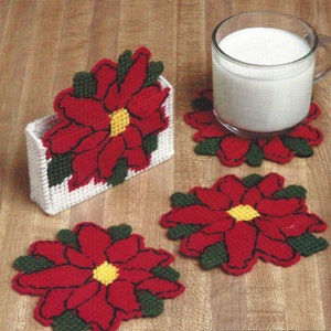 May include: Set of four red and green poinsettia coasters with a matching poinsettia design holder. The coasters are made of plastic canvas and are perfect for adding a festive touch to your home decor.