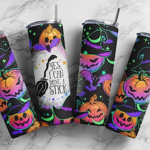 May include: Four black Halloween-themed tumblers with lids and straws. The tumblers feature a repeating pattern of jack-o'-lanterns, witch hats, bats, and stars in neon colors. One tumbler has the text "Yes, I can drive a stick."