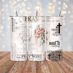 May include: Three white stainless steel tumblers with black straws. Each tumbler features religious text and imagery, including crosses, floral arrangements, and inspirational quotes. The designs are in shades of gold, pink, and black.