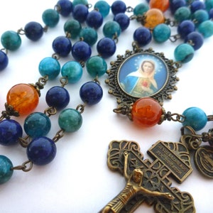 Rosary Flame of Love, 8mm light blue jade, 8mm dyed lapis, 10mm fire agate, caps, spacers. Medallion, Pardon crucifix, St. Benedict charm