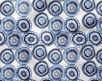 May include: A seamless pattern featuring blue and white concentric circles with a textured, hand-drawn look. The circles are arranged in a random pattern on a white background.