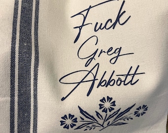 Fuck Greg Abbott tea towel in blue.