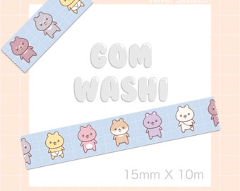 May include: A blue and white washi tape with a repeating pattern of cute cartoon bears wearing diapers. The tape is 15mm wide and 10m long. The text "COM WASHI" is written in white on a white background. The text "Velvet Skeleton" is written in black on a white background.