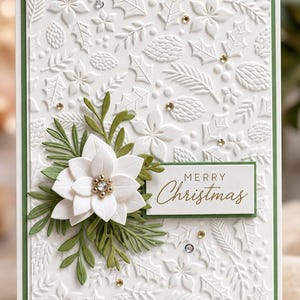May include: A rectangular greeting card with a white embossed background featuring holly leaves, pine cones, and poinsettias. A layered white poinsettia with a gold center sits on green foliage. A white label reads Merry Christmas in gold.