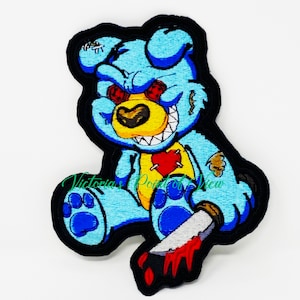 May include: A blue teddy bear with red eyes and a stitched heart on its chest is holding a bloody knife. The bear has a menacing grin and appears to be a creepy, stitched-together toy.