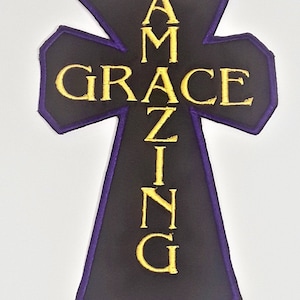 May include: A purple and black cross-shaped patch with the words "Amazing Grace" embroidered in gold.