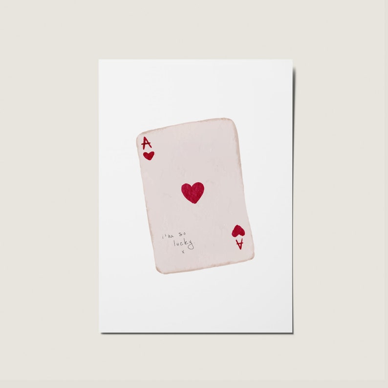 May include: A white playing card with a red ace of hearts symbol and the text "I'm so lucky" written on it.