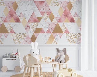 May include: A children's room with a geometric wallpaper featuring pink, gold, and marble-like triangles. The room includes a small wooden table and chairs, a yellow rug, and various toys, including a stuffed elephant and a white bunny.