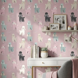 May include: Pink wallpaper featuring a repeating pattern of stylized poodles in various colors, including black, white, and pastel shades of blue and pink. The wallpaper is used as a backdrop for a white desk, chair, and decorative items.