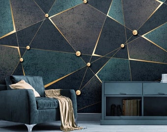 May include: A dark blue armchair with a gold throw blanket sits in front of a wall with a geometric pattern of gold lines and circles on a dark blue and green background.