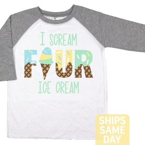 May include: White and grey baseball tee shirt with the text "I scream four ice cream" with the number four made of ice cream cones.