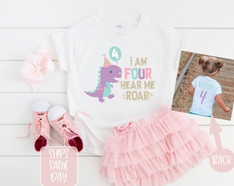 May include: White t-shirt with a purple dinosaur holding a balloon that says "4". The text on the shirt says "I am Four Hear Me Roar". The back of the shirt has a white "4" on it.