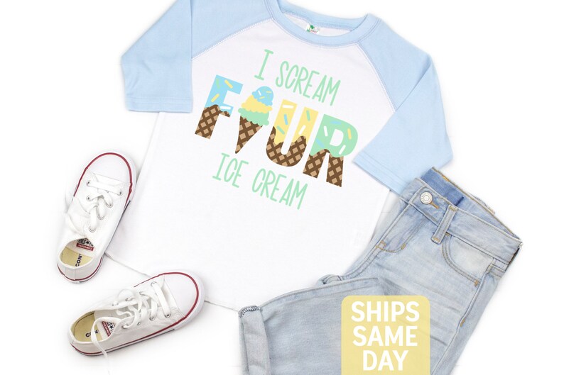May include: White and light blue raglan t-shirt with the text "I scream four ice cream" in colorful letters that are decorated with ice cream cones. The letters are decorated with sprinkles and waffle cone patterns.