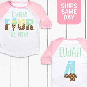 May include: A white and pink baseball tee shirt with the text "I scream for ice cream" and a graphic of an ice cream cone with sprinkles. The back of the shirt has the name "Elijah" and the number "4" with an ice cream cone graphic.