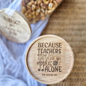 May include: Wooden jar lid with the text "Because teachers can't live on apples alone" and the text "From Adam Rad. 2024".