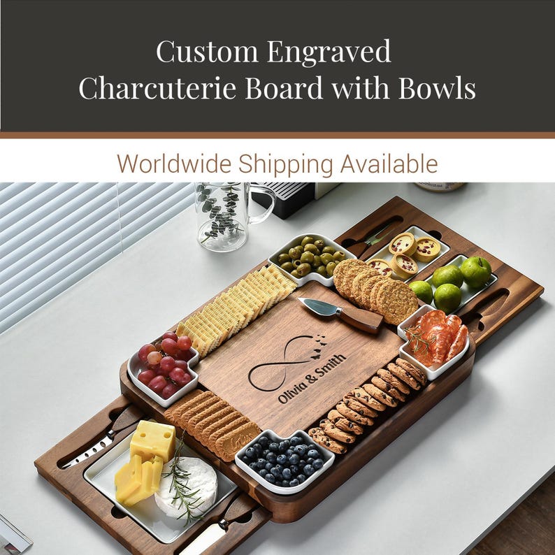 a custom engraved charcuterie board with bowls, showcasing a variety of food items such as crackers, cheese, grapes, olives, and other appetizers. The board is accompanied by a knife and a bowl, and the text "Custom Engraved Charcuterie Board with Bowls" and "Worldwide Shipping Available" are displayed above the board.